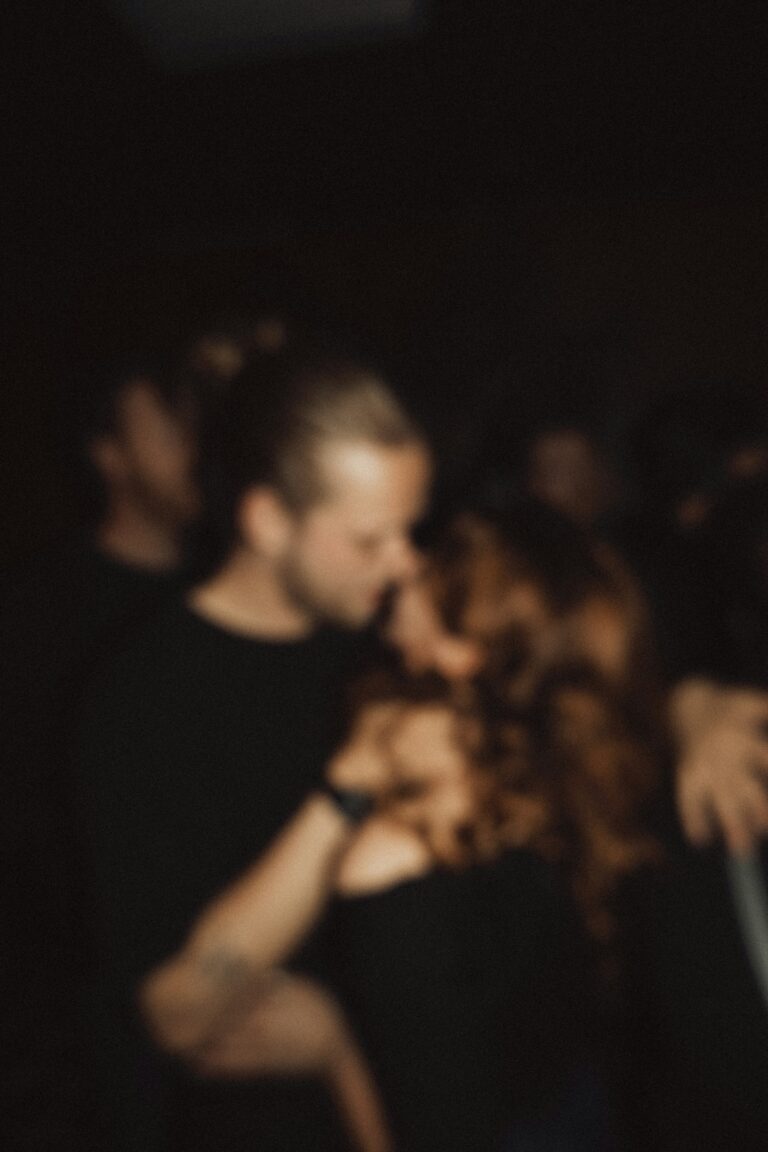 Two coffee cups on a wooden table in a warm café setting