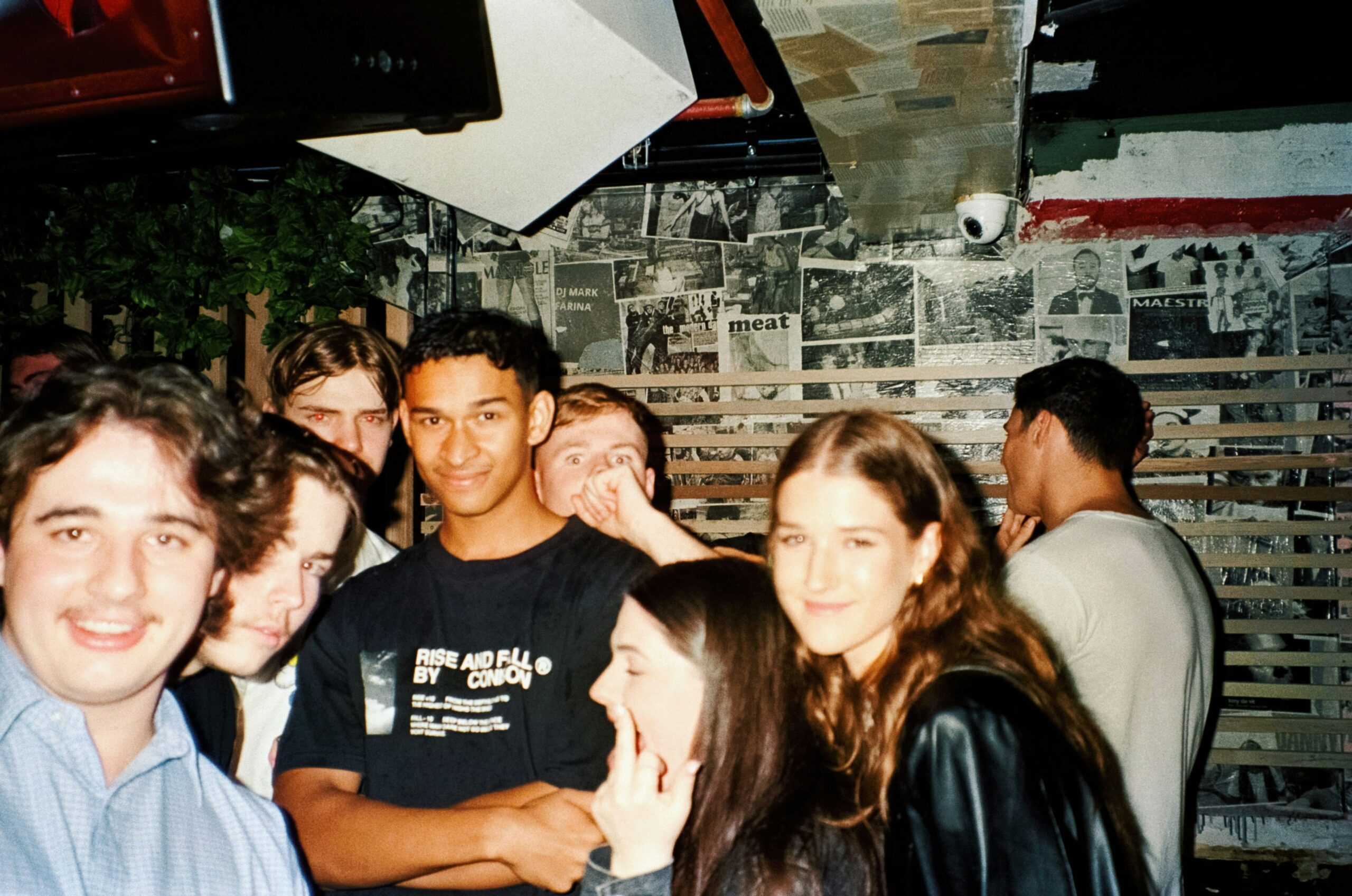 Group of young adults laughing together at a social gathering