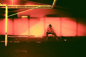 Vivid red and orange sunset light filling a room through large windows