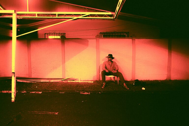 Vivid red and orange sunset light filling a room through large windows