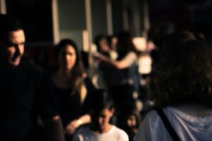 Group of people gathered together in a dimly lit setting