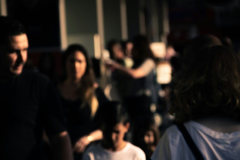 Group of people gathered together in a dimly lit setting