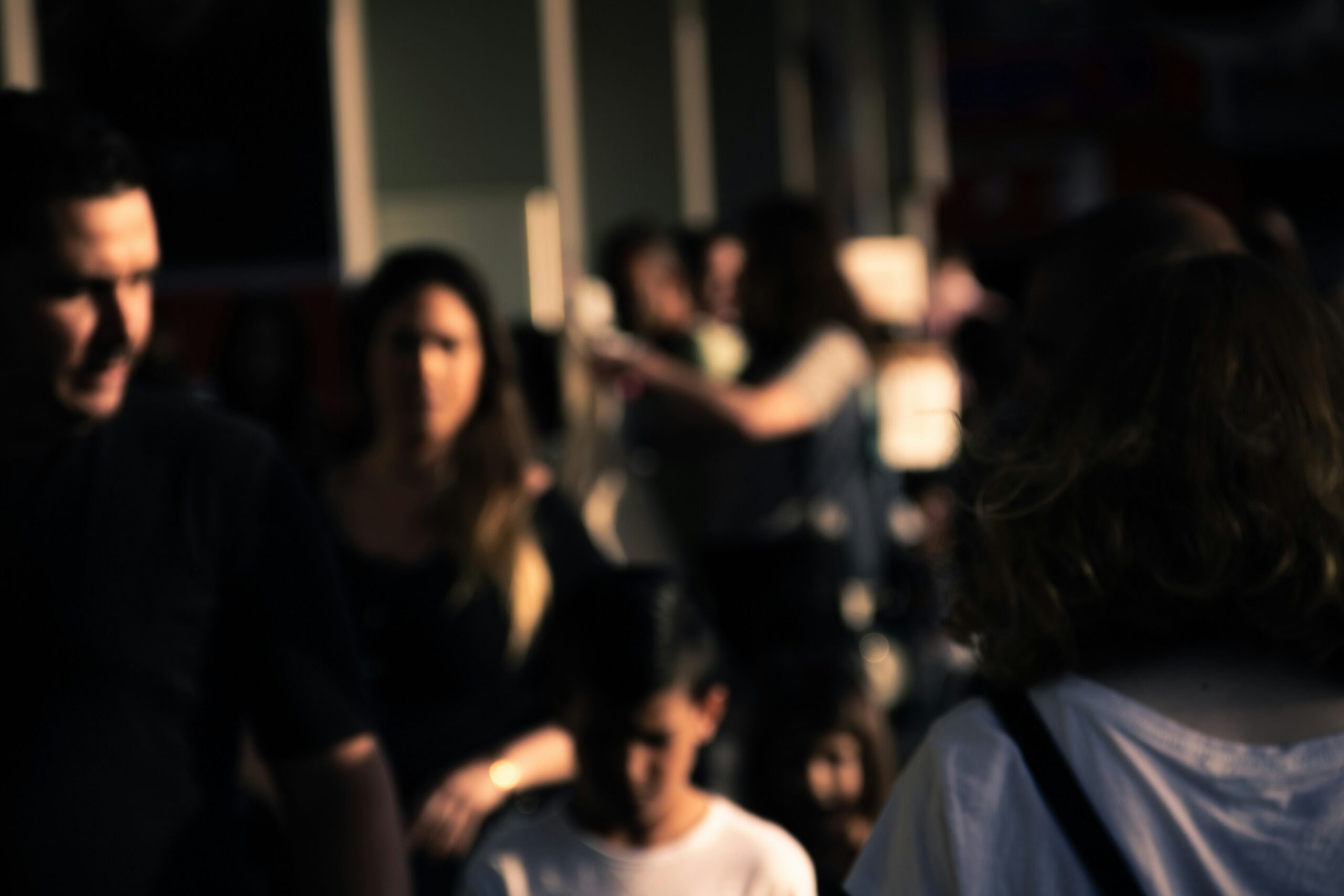 Group of people gathered together in a dimly lit setting
