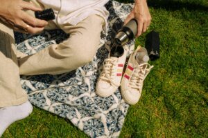 Person holding a camera while wearing sneakers, capturing real-life moments and honest dating advice from strangers