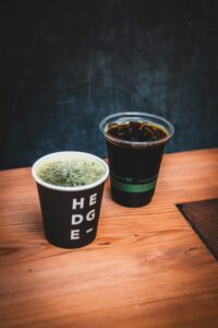 Hands wrapped around a warm coffee cup in a cozy intimate setting