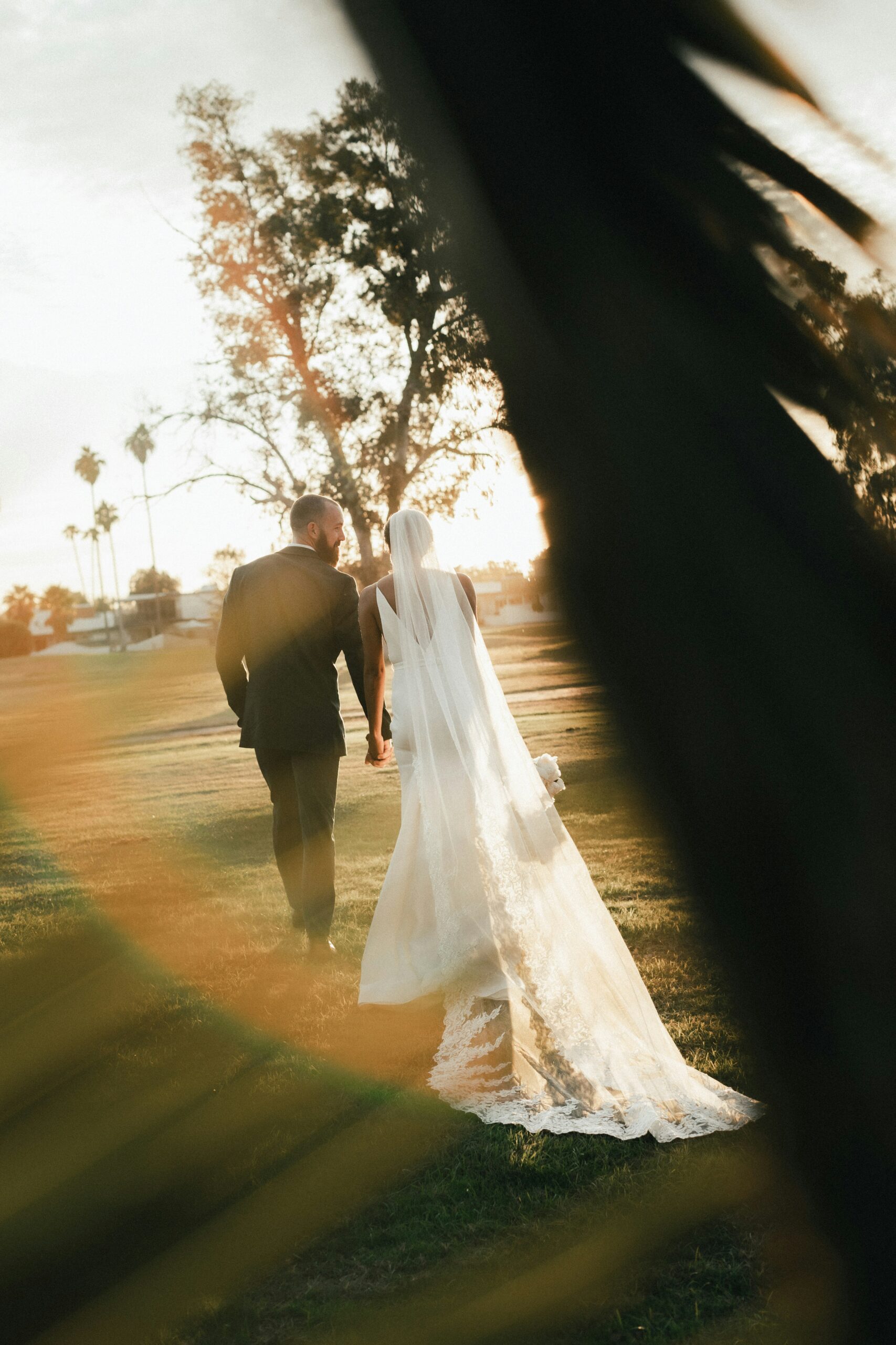 Couple lying together on green grass outdoors in natural light