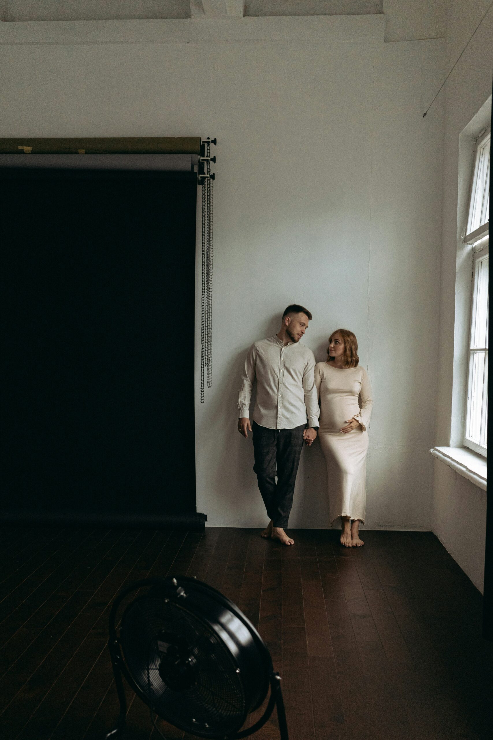 Couple walking through a dimly lit hallway, reflecting the challenges and growth that come with learning to be a godly husband