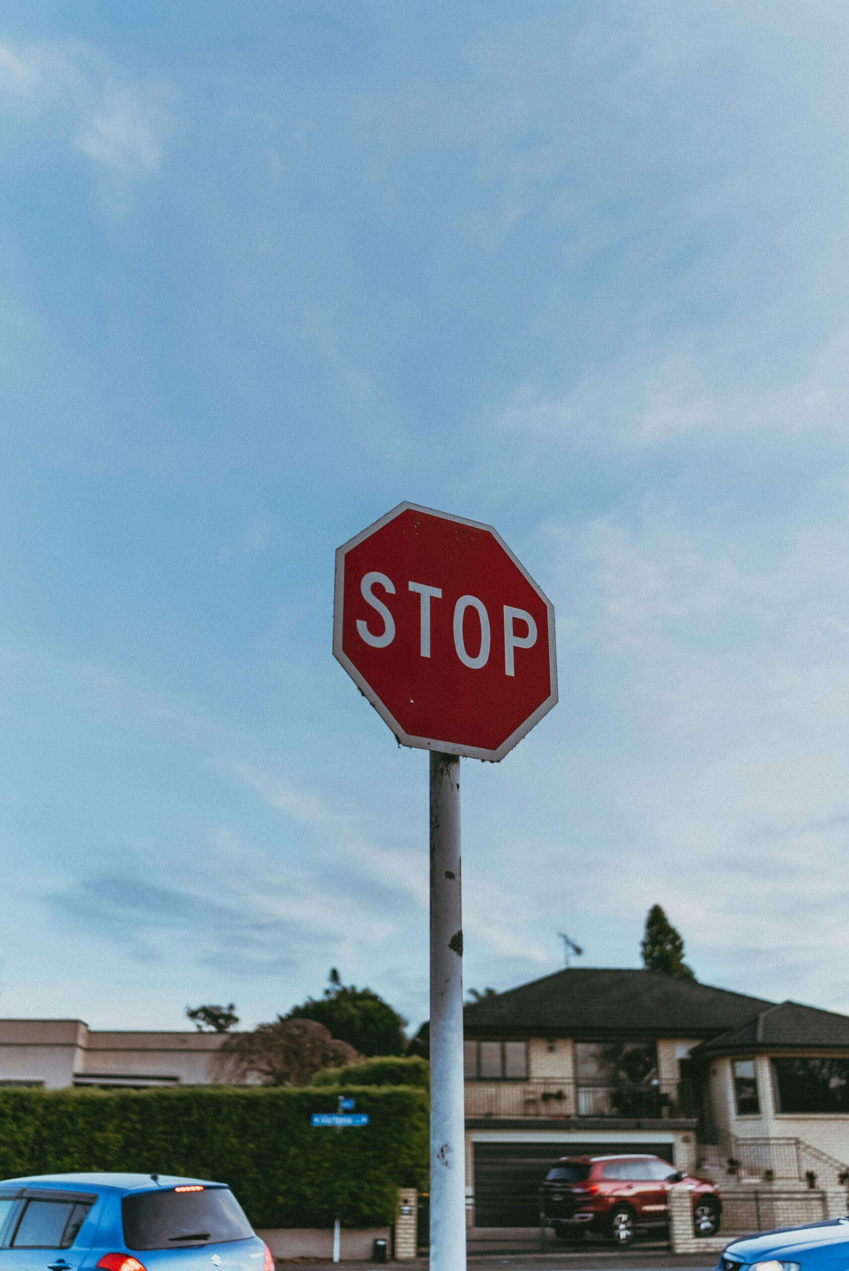 Red stop sign standing against a clear sky