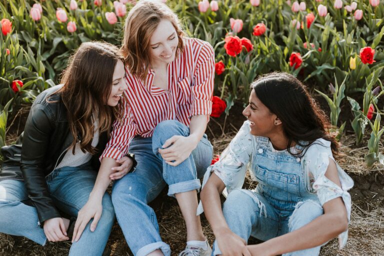 Women laughing together in a colorful tulip field, representing what Christian women really look for in a future husband